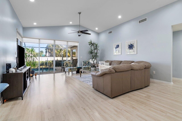 living room with high vaulted ceiling, light hardwood / wood-style floors, and ceiling fan