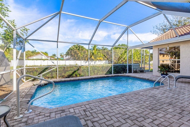 view of swimming pool with a lanai and a patio area