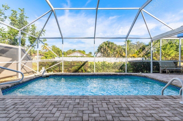 view of swimming pool with a patio and a lanai