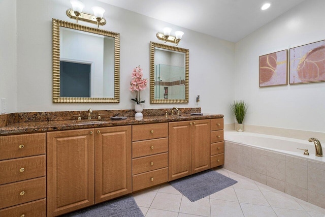 bathroom featuring tile patterned flooring, vanity, and shower with separate bathtub