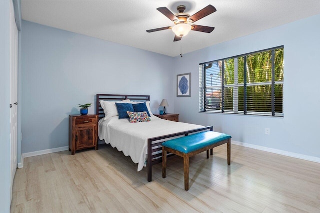 bedroom featuring light wood-type flooring and ceiling fan