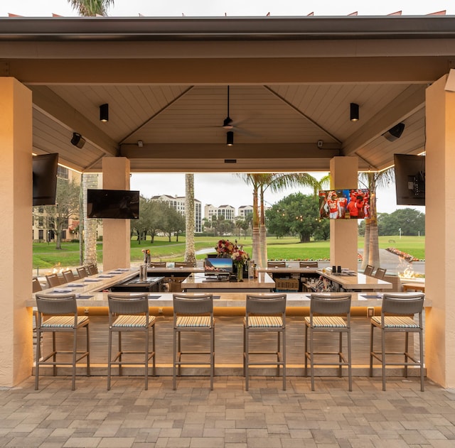 view of patio with a gazebo, ceiling fan, and an outdoor bar