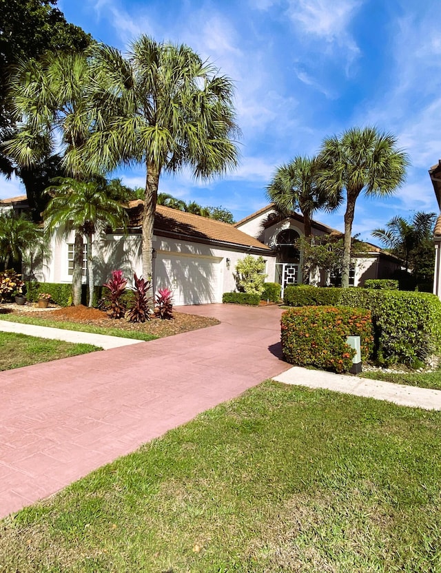 view of front facade with a garage and a front lawn