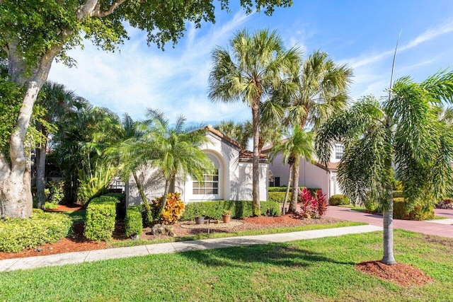 mediterranean / spanish-style house with a front lawn