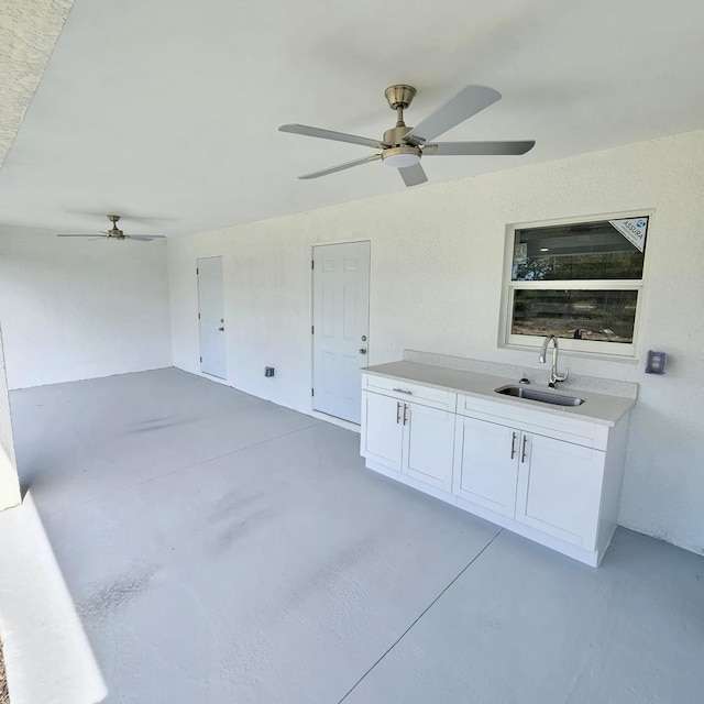 view of patio with sink, ceiling fan, and exterior kitchen