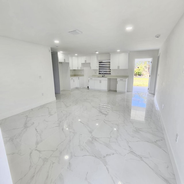 unfurnished living room featuring sink