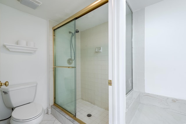 bathroom featuring an enclosed shower and toilet