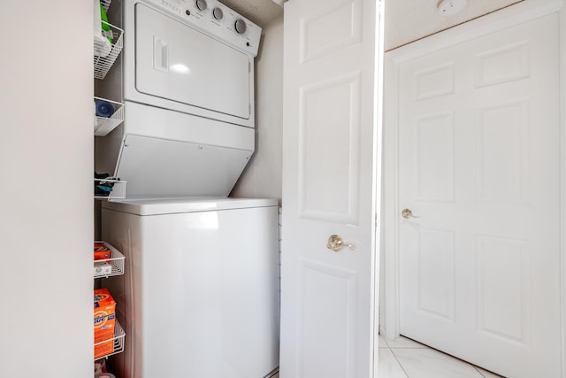 washroom featuring stacked washer and dryer