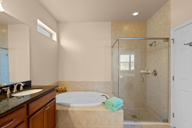 bathroom featuring vanity and separate shower and tub