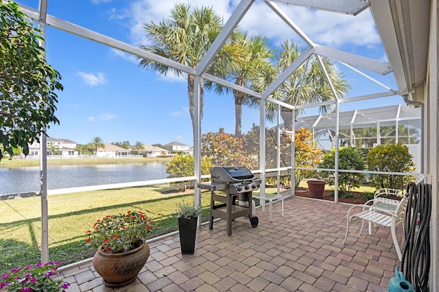 sunroom / solarium featuring a water view