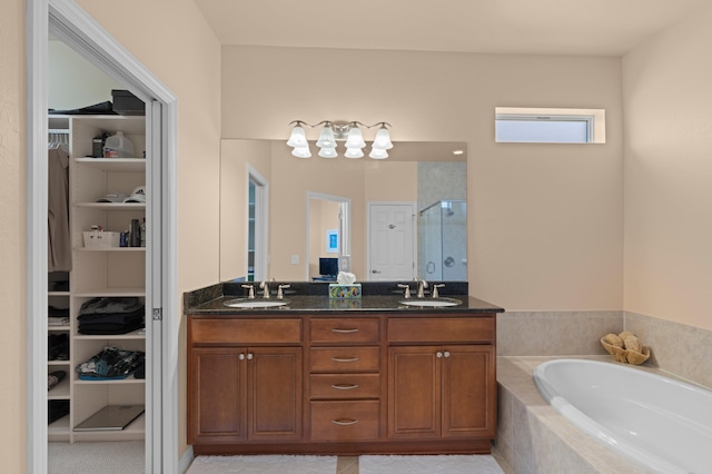 bathroom with a sink, a spacious closet, and a shower stall