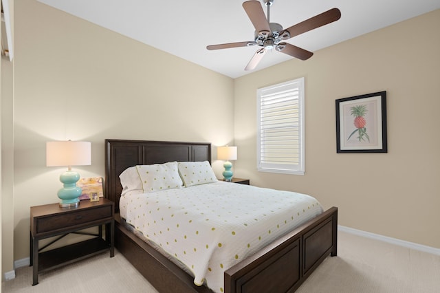 bedroom featuring baseboards, ceiling fan, and light colored carpet