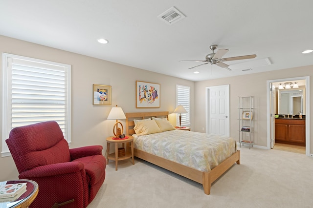 bedroom with light carpet, visible vents, ceiling fan, ensuite bathroom, and recessed lighting