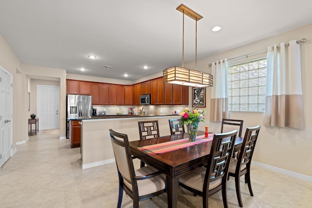 dining room with light tile patterned floors, baseboards, visible vents, and recessed lighting