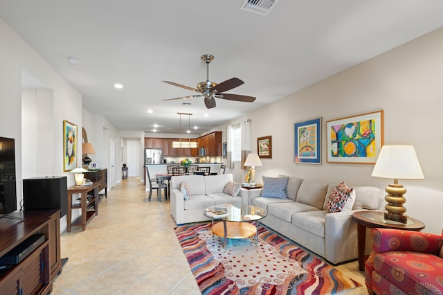 living room featuring light tile patterned flooring, ceiling fan, visible vents, and recessed lighting