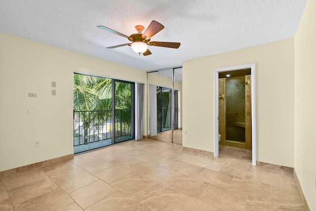 spare room featuring ceiling fan and a textured ceiling