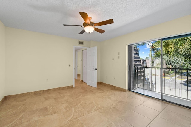 spare room featuring ceiling fan and a textured ceiling