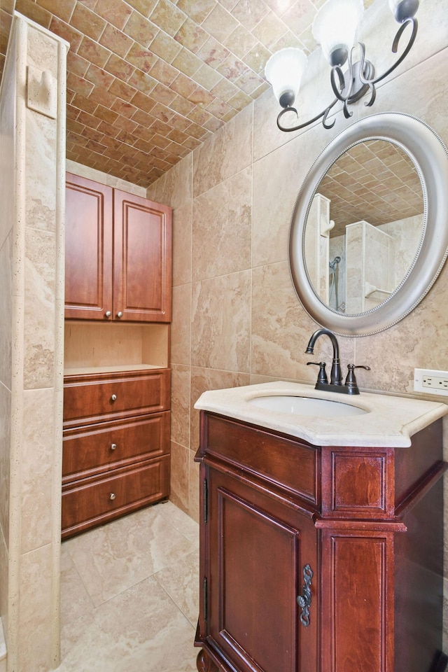 bathroom with brick ceiling, vanity, and tile walls