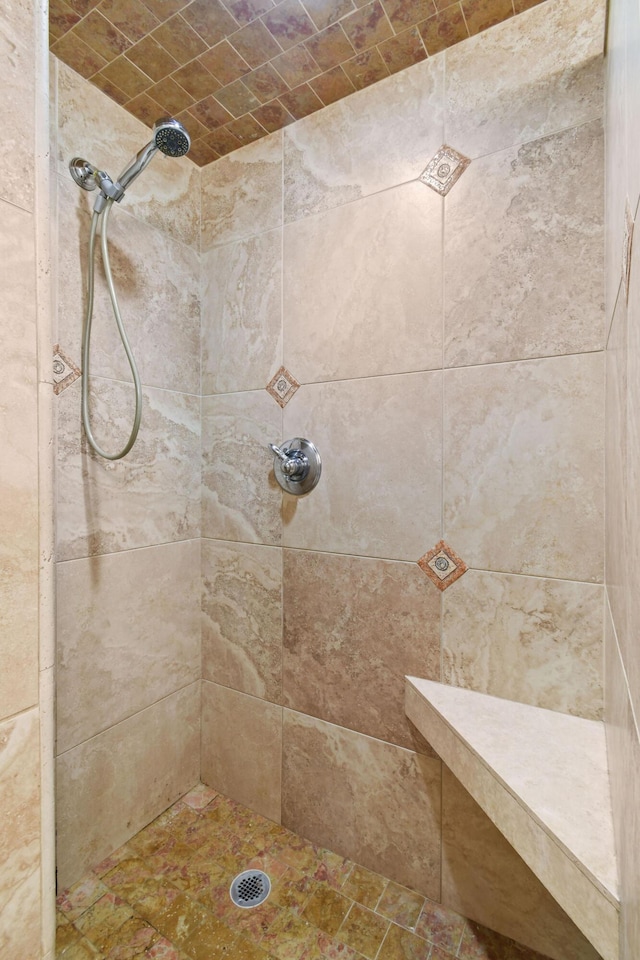 bathroom with a tile shower