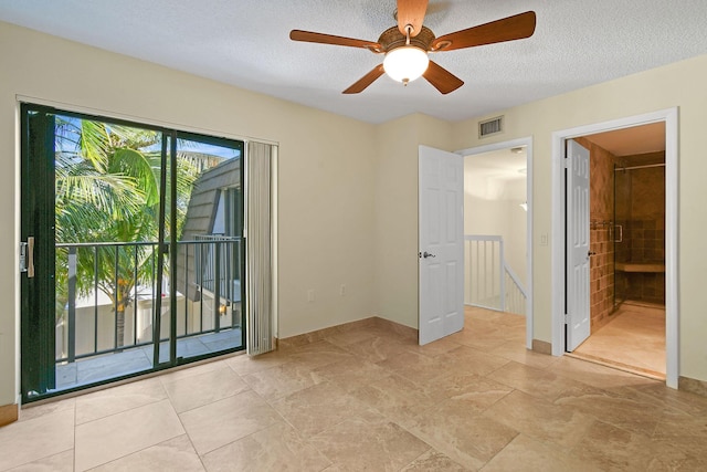 empty room featuring ceiling fan and a textured ceiling