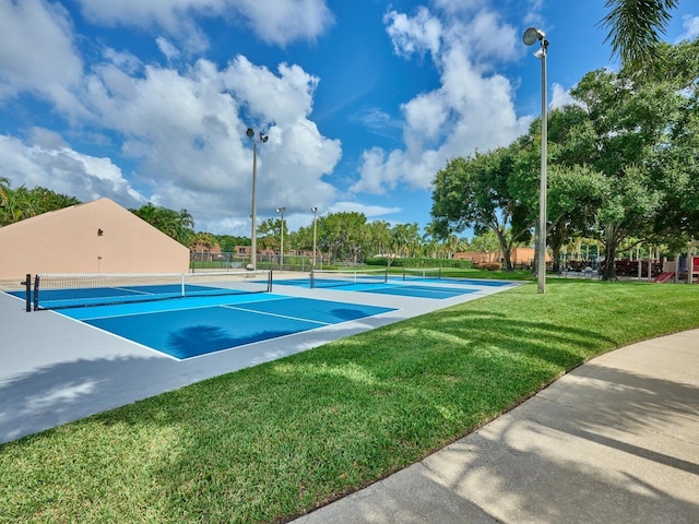 view of sport court featuring a yard