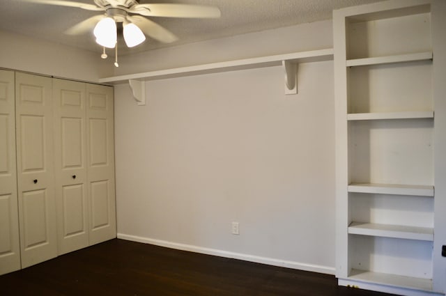 unfurnished bedroom with dark hardwood / wood-style flooring, ceiling fan, a closet, and a textured ceiling