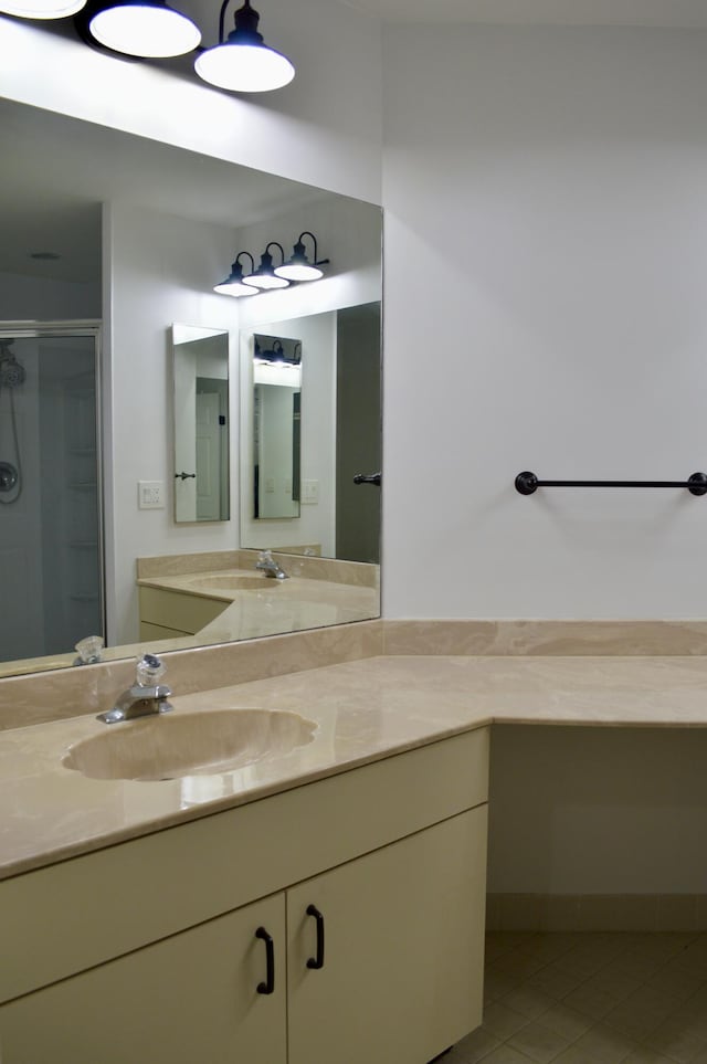 bathroom featuring vanity, tile patterned flooring, and a shower with door