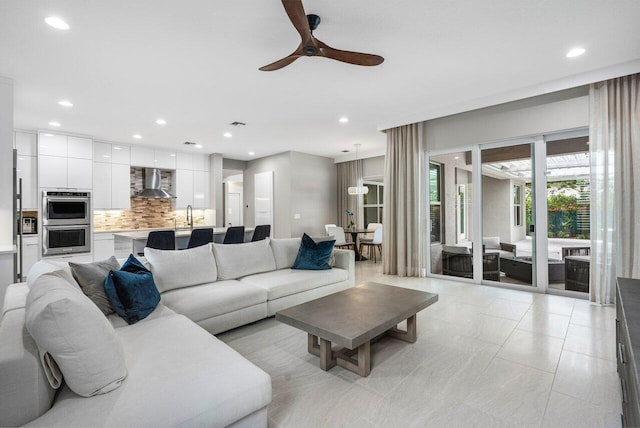 living room featuring light tile patterned flooring and ceiling fan