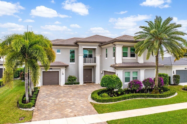 view of front facade with a garage and a front lawn