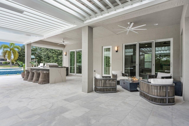 view of patio featuring ceiling fan, a swimming pool, and an outdoor living space with a fire pit