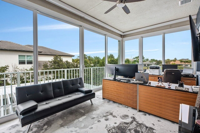 sunroom featuring ceiling fan