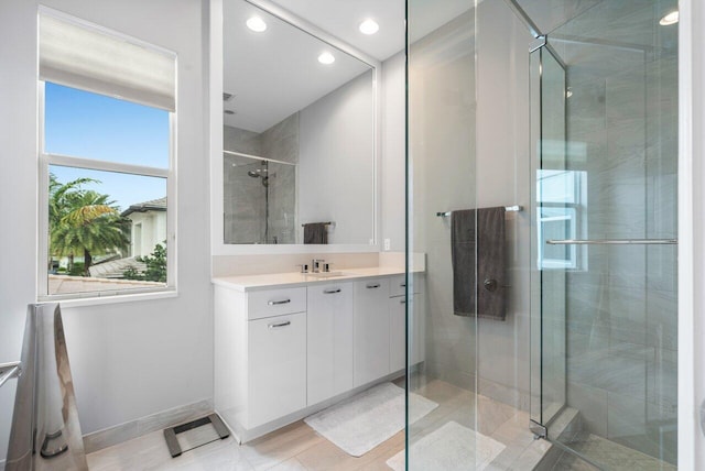 bathroom with an enclosed shower and vanity