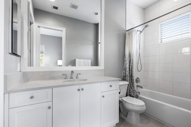 full bathroom featuring vanity, tile patterned floors, toilet, and shower / bath combo