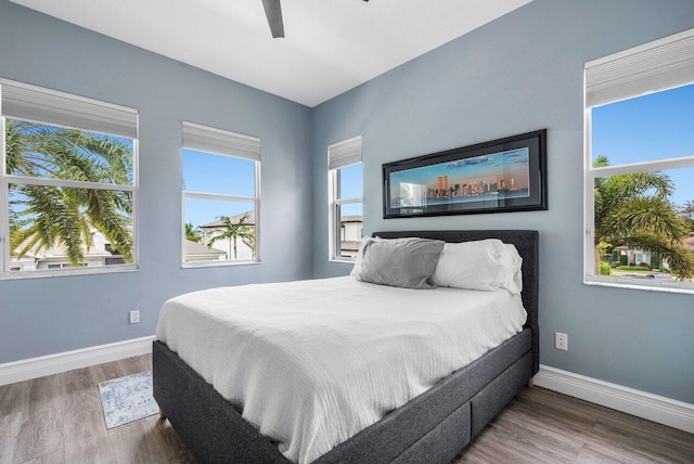 bedroom with hardwood / wood-style floors and ceiling fan