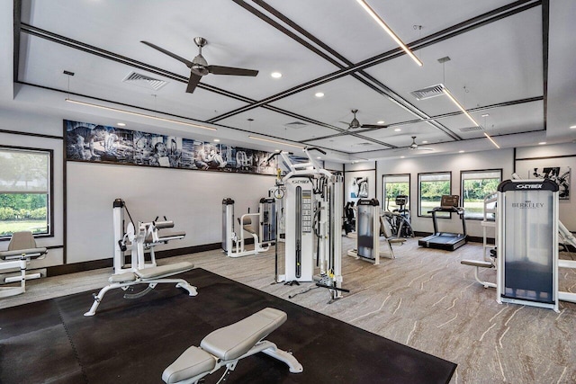 workout area with coffered ceiling and ceiling fan