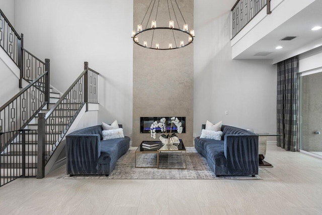 living room featuring an inviting chandelier and a towering ceiling