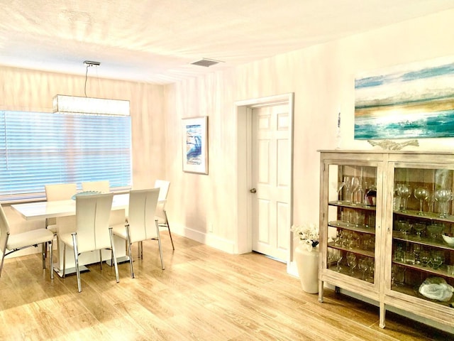 dining space with light wood-type flooring