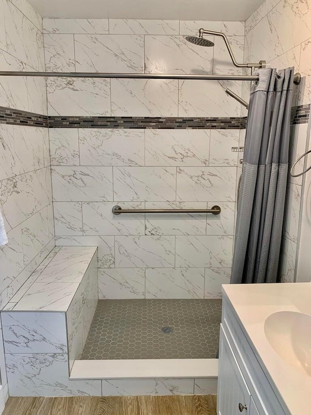 bathroom featuring vanity and curtained shower