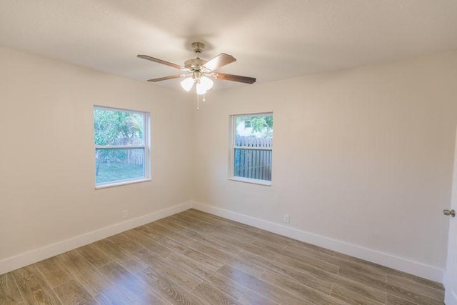 empty room with ceiling fan and hardwood / wood-style floors