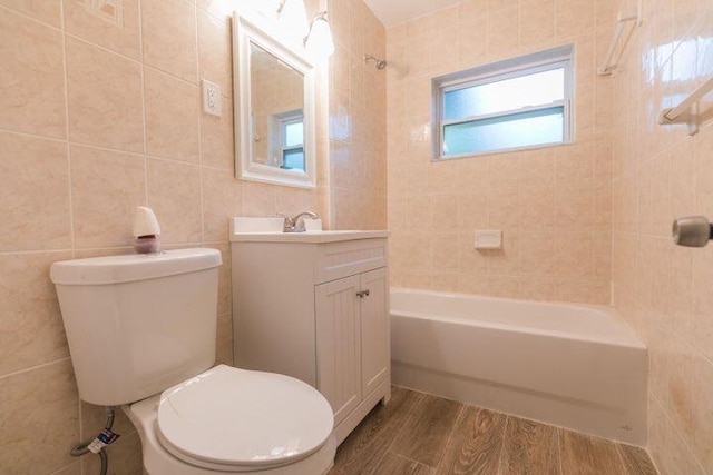 full bathroom with hardwood / wood-style flooring, vanity, toilet, and tile walls