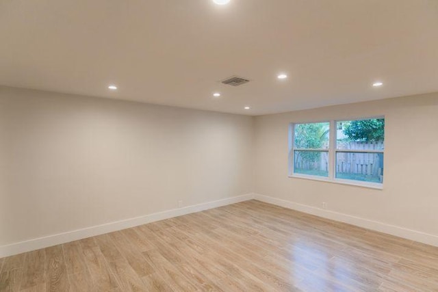 unfurnished room with light hardwood / wood-style floors