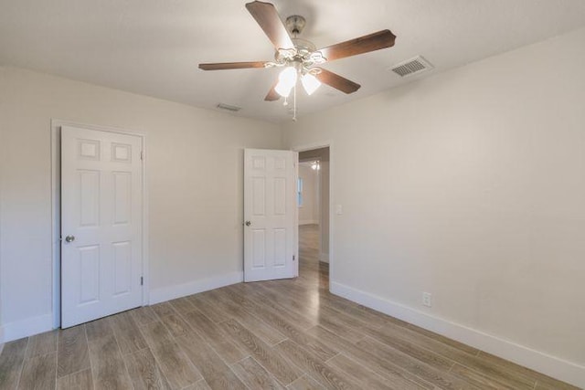 unfurnished bedroom with ceiling fan and light hardwood / wood-style floors