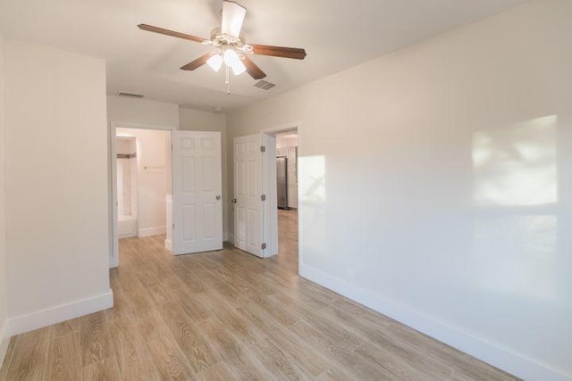 empty room with ceiling fan and light wood-type flooring