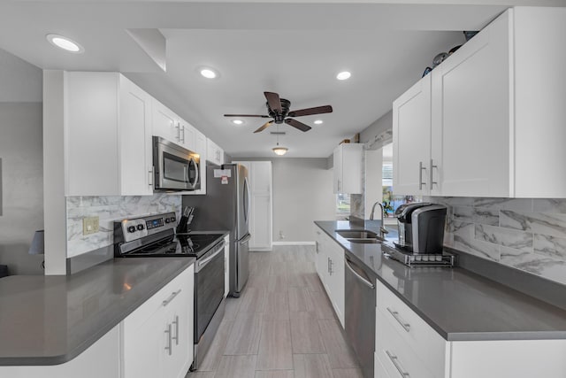 kitchen with white cabinetry, ceiling fan, appliances with stainless steel finishes, and sink