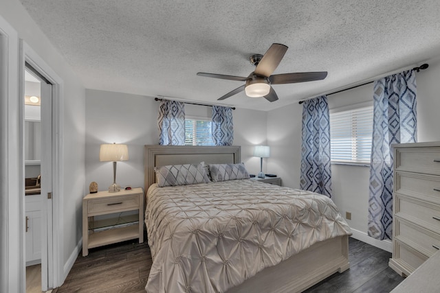 bedroom featuring dark hardwood / wood-style flooring, multiple windows, and a textured ceiling