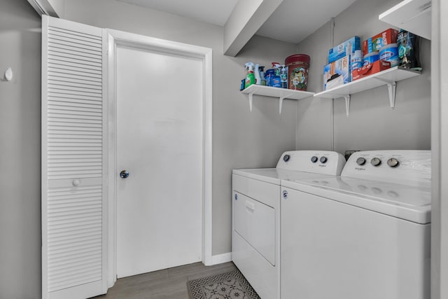 washroom featuring washing machine and clothes dryer and hardwood / wood-style floors