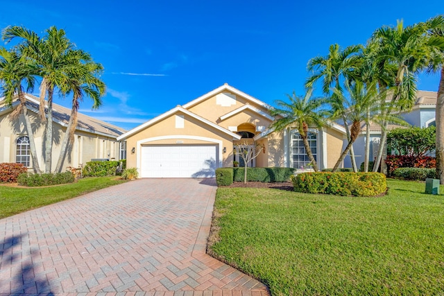 view of front of home with a garage and a front lawn