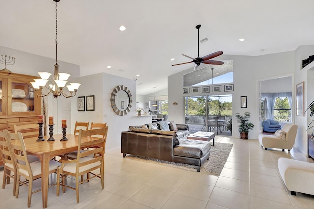 living room featuring vaulted ceiling, ceiling fan with notable chandelier, and light tile patterned floors