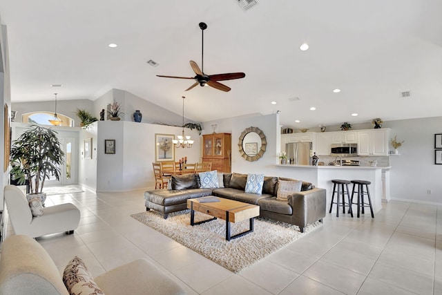 living room featuring ceiling fan with notable chandelier, light tile patterned floors, and high vaulted ceiling