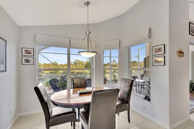 tiled dining area featuring lofted ceiling and plenty of natural light